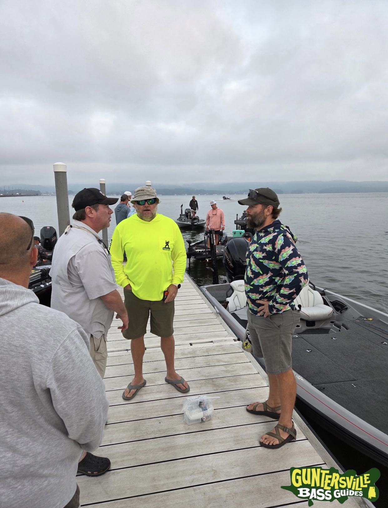 On-the-water action during a Lake Guntersville group fishing outing with multiple guide boats